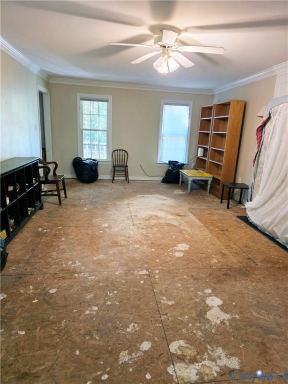 Multi-purpose interior room featuring crown molding, dual grid-pattern windows, and a ceiling-mounted light fixture with a fan