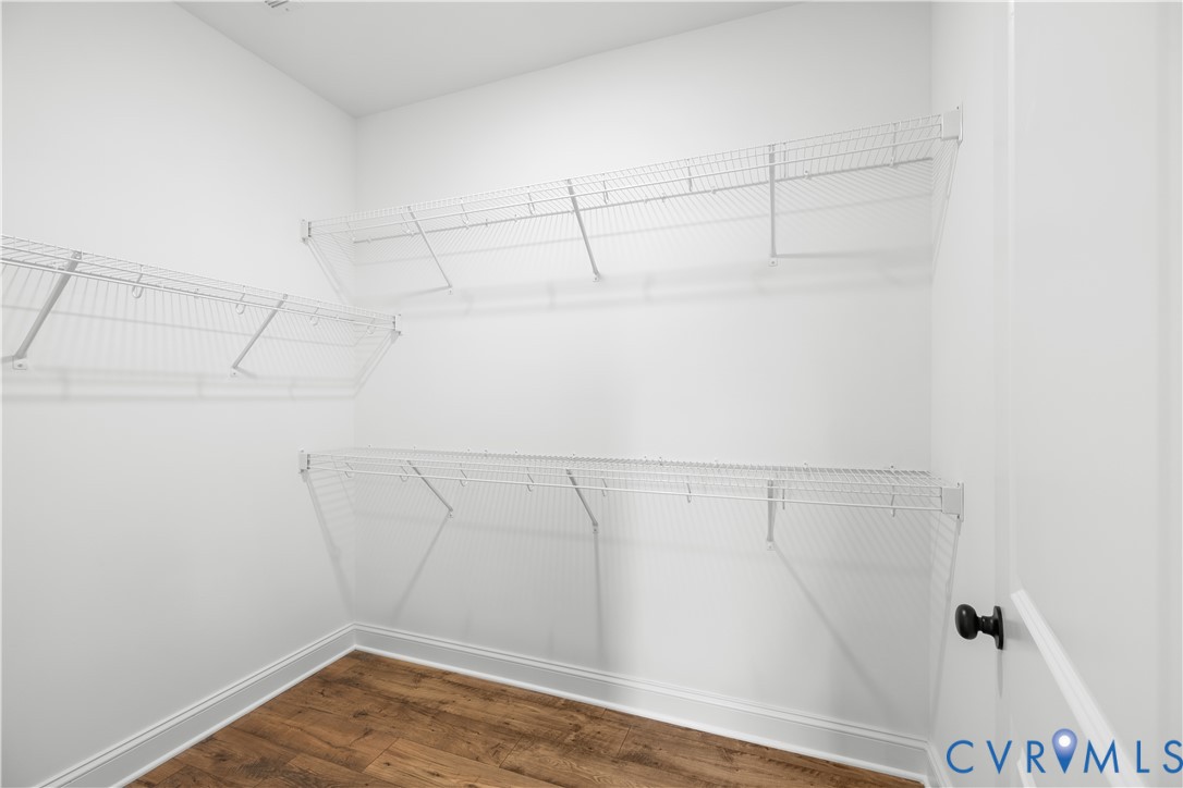 Interior room with white walls and wood-finish flooring