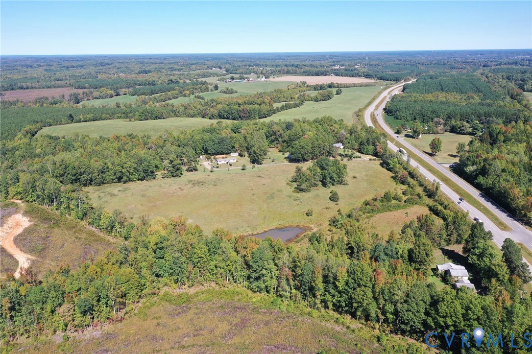 Expansive acreage featuring mature tree lines, open pastoral fields, and a natural pond Expansive acreage featuring mature tree lines, open pastoral fields, and a natural pond