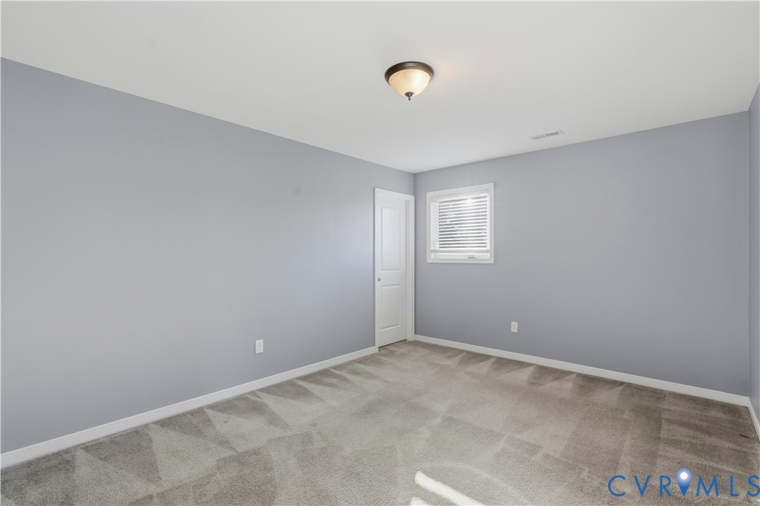 Bedroom #3 Room featuring neutral-toned carpeting, light gray wall paint, a single-panel interior door, a recessed window with horizontal blinds, and a dome-style flush-mount ceiling light