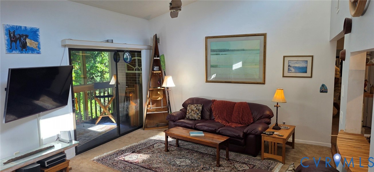 Vaulted ceilings, sliding glass door, and wooden pass-through counter Vaulted ceilings, sliding glass door, and wooden pass-through counter