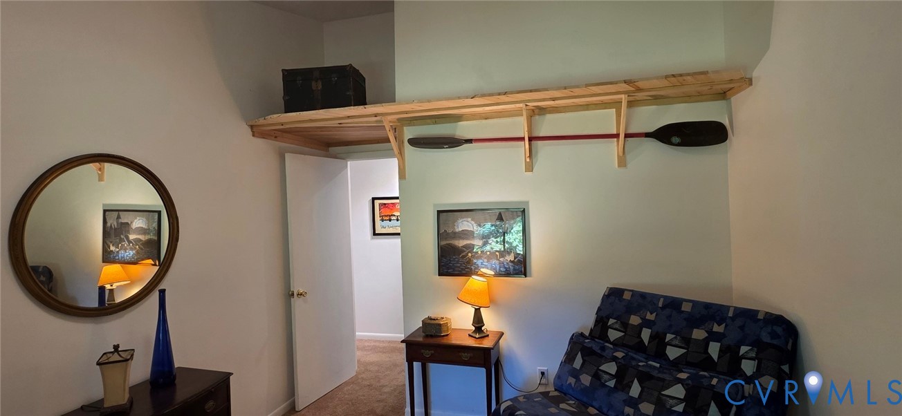 Custom built-in wood shelving with decorative brackets and neutral-toned wall paint