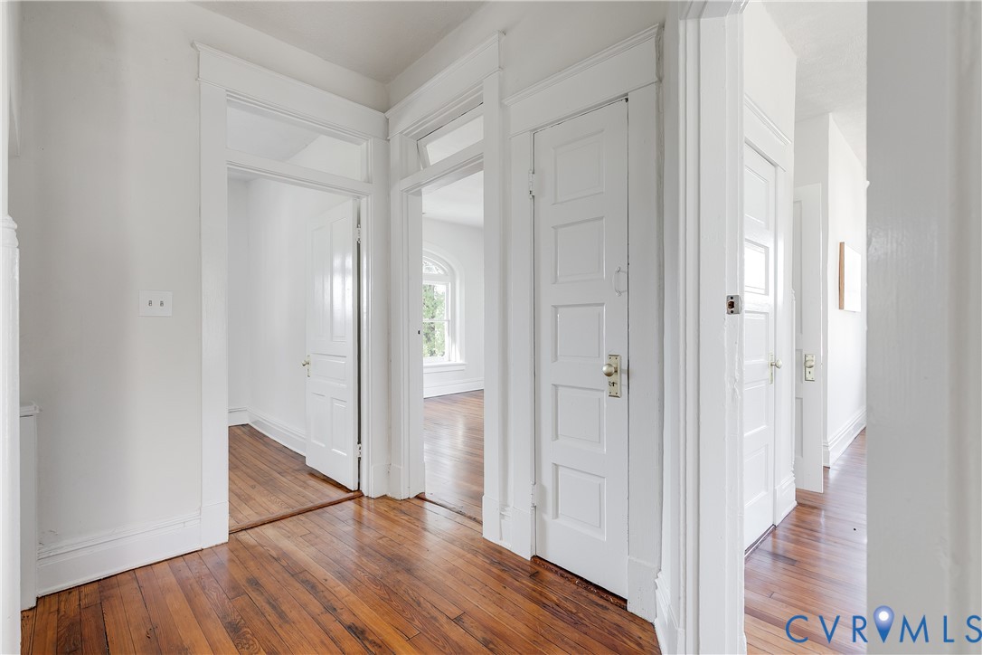 Hardwood flooring, five-panel interior doors, transom windows, and period-style door casings