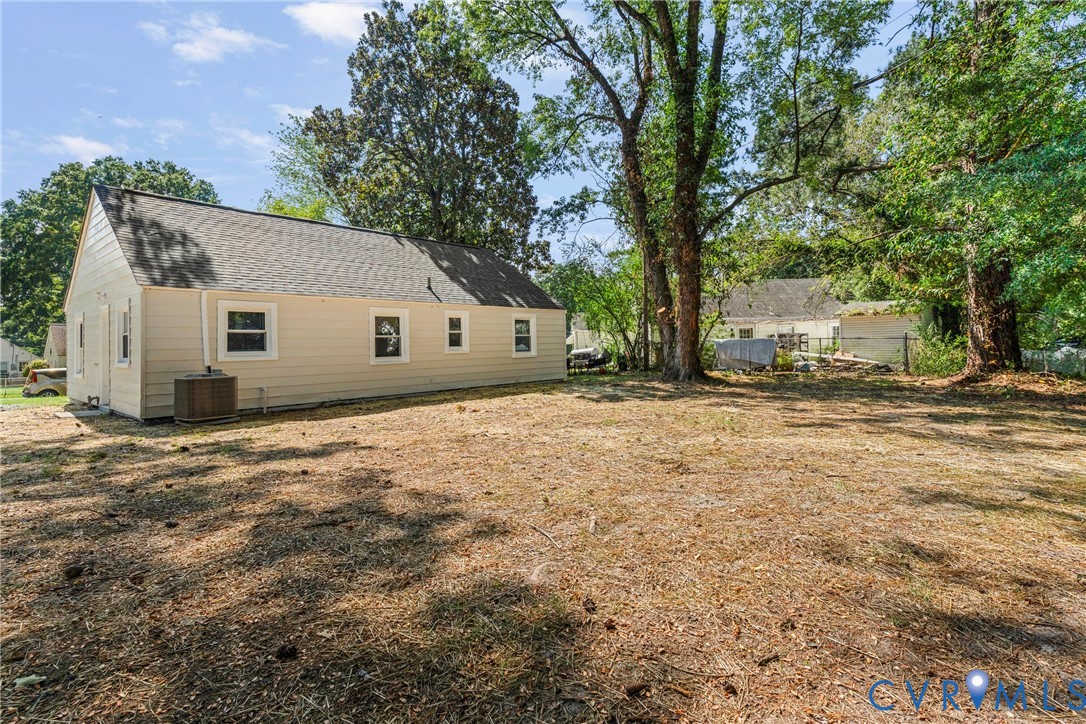Charming single-story home situated on an expansive lot with mature shade trees