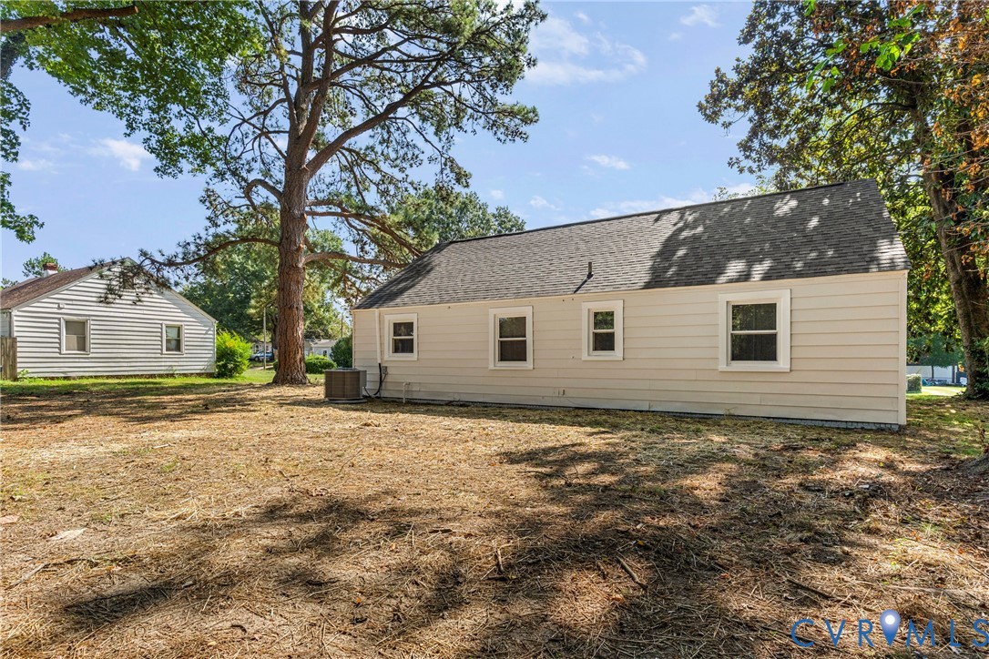 Light-colored siding exterior with white window trim and a dark shingle roof