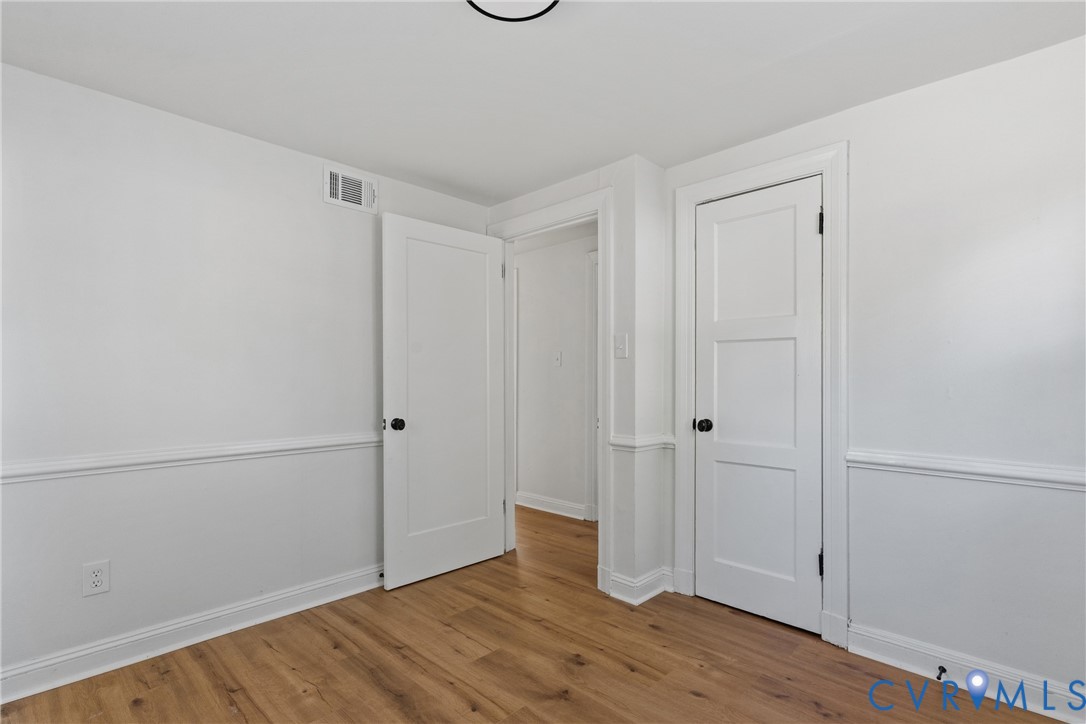 Wood-finish flooring, white walls, and bright white trim