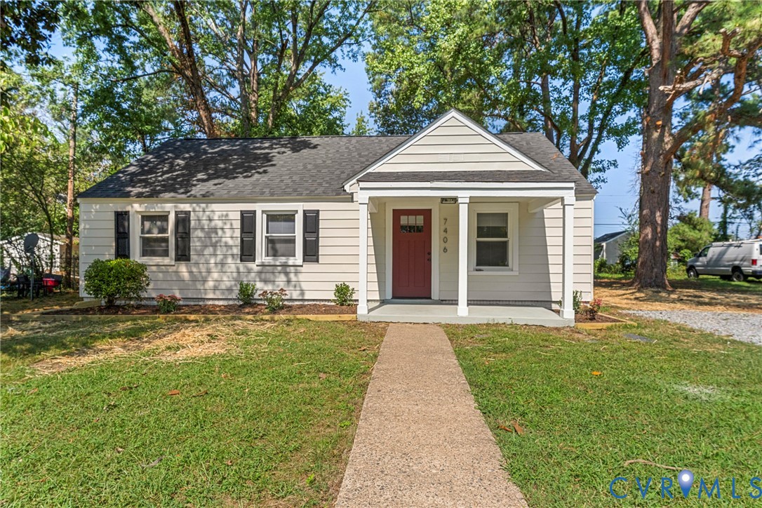 Traditional exterior with light-colored siding, dark shingle roof, and a covered front porch with white columns Traditional exterior with light-colored siding, dark shingle roof, and a covered front porch with white columns
