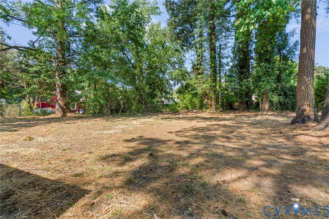 Expansive lot featuring mature trees and a cleared, level building area