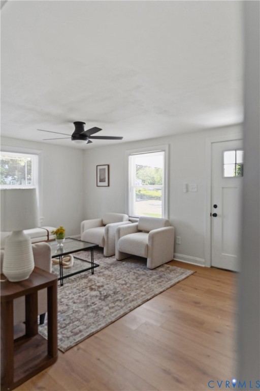 Wood-finish flooring, white walls, and a ceiling fan with integrated lighting Wood-finish flooring, white walls, and a ceiling fan with integrated lighting