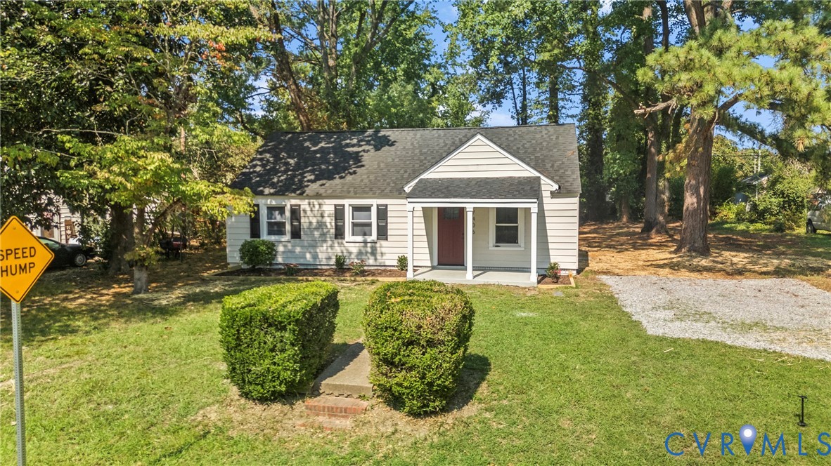 Gabled roofline with white siding, red front door, and a covered porch
