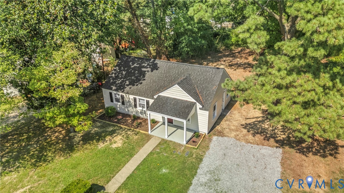Gable roof home with light-toned siding and dark shutters