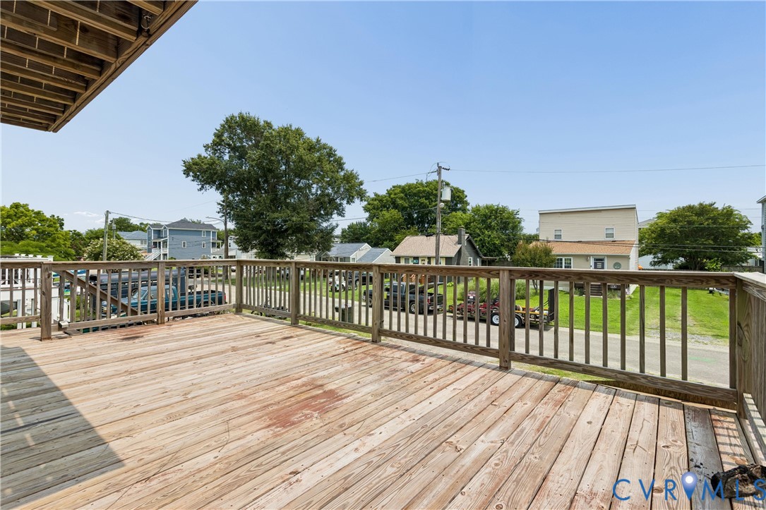 Elevated wood deck featuring a wooden railing and a plank surface