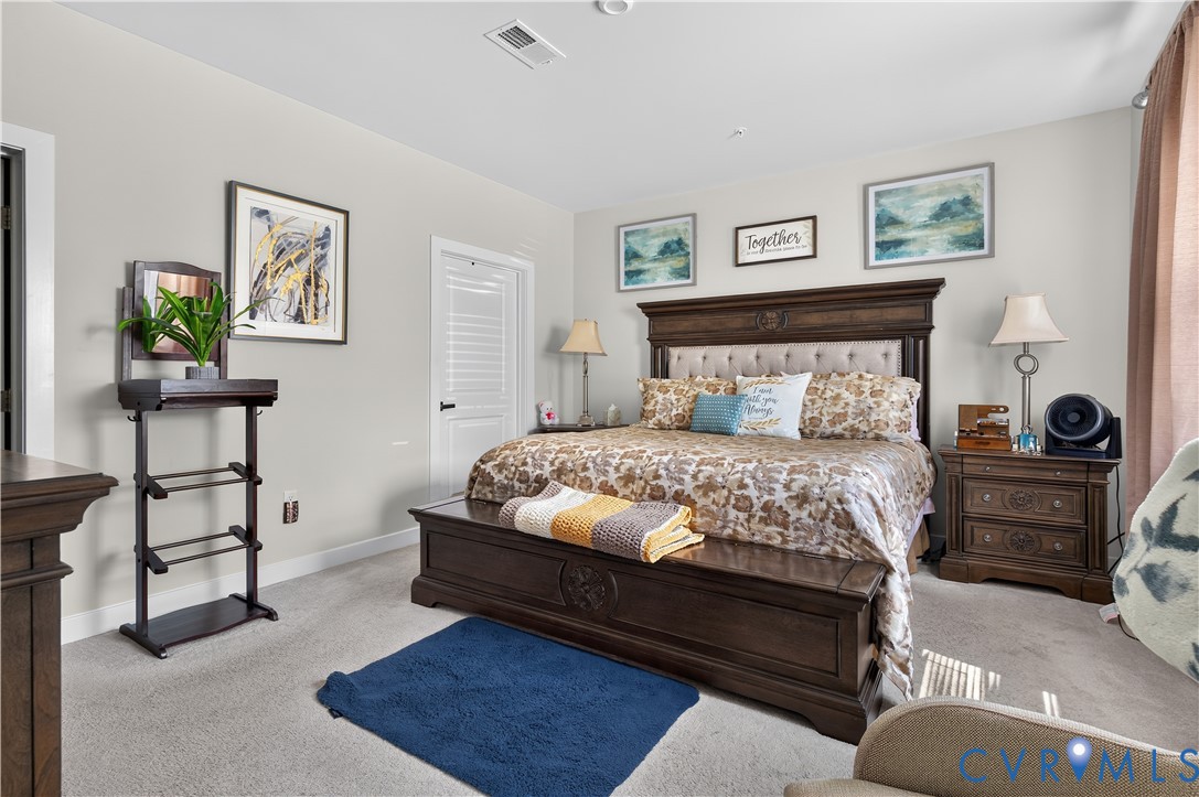 Neutral-toned interior featuring wall-to-wall carpeting and a multi-panel door