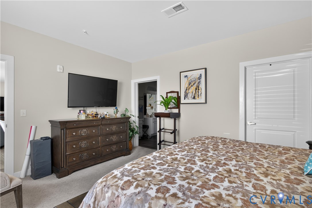 Neutral-toned interior space featuring light-colored wall paint, carpeted flooring, two interior passage doors, and recessed ceiling lighting