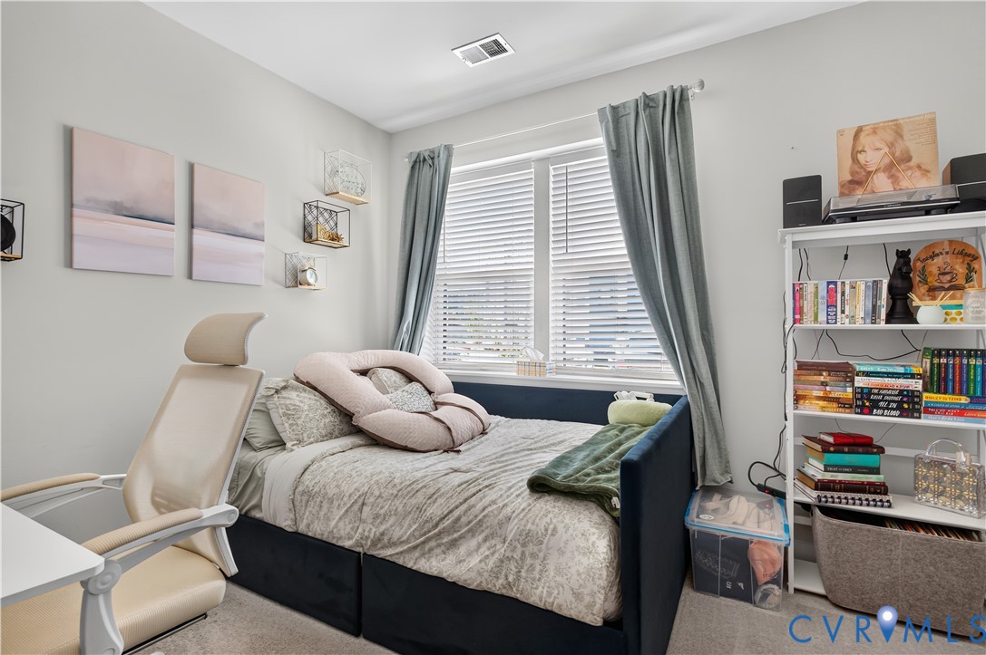 Neutral interior space featuring neutral wall paint, carpeting, and a double-pane window with adjustable blinds