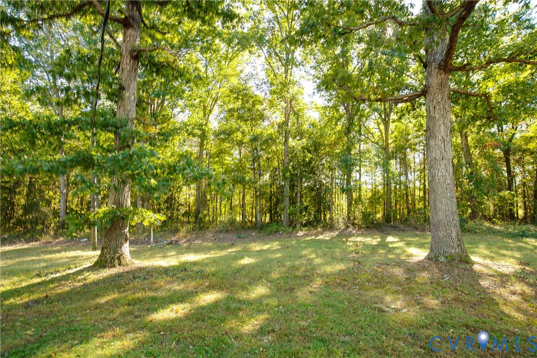 Expansive grounds featuring mature shade trees and level lawn space