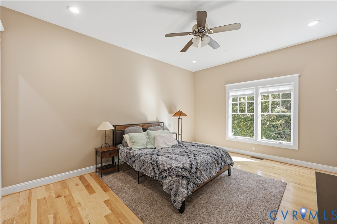 Primary Bedroom 2. Room featuring wood-finish flooring, recessed lighting, a ceiling fan, and a multi-pane window