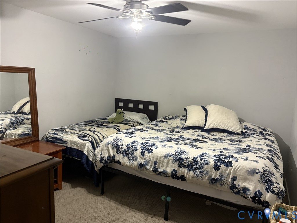 Room featuring wall-to-wall carpeting and a ceiling-mounted fan with integrated lighting