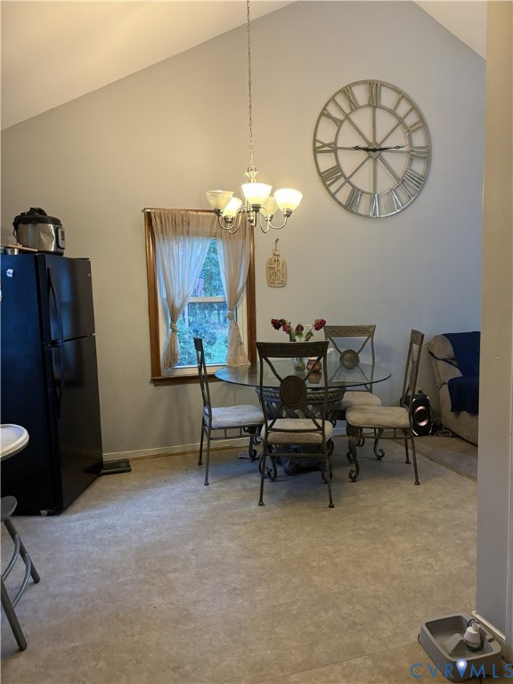 Vaulted ceiling featuring a central five-light chandelier and a single-hung window with wood-trim finish