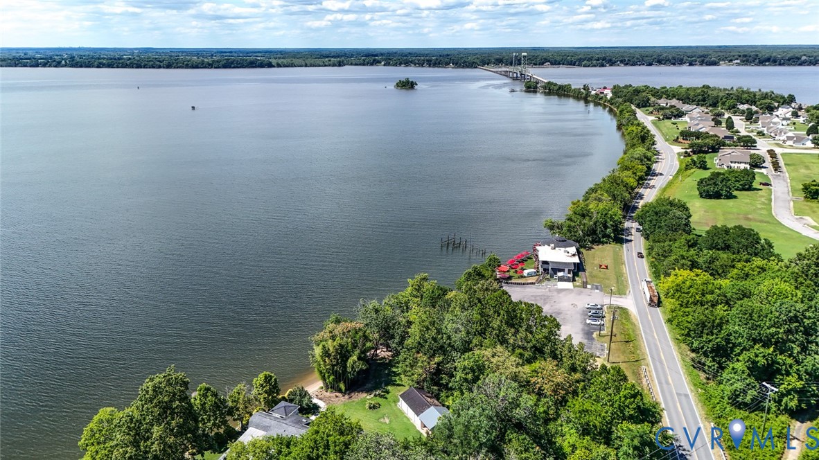 Waterfront property featuring extensive shoreline, mature trees, and direct access to open water