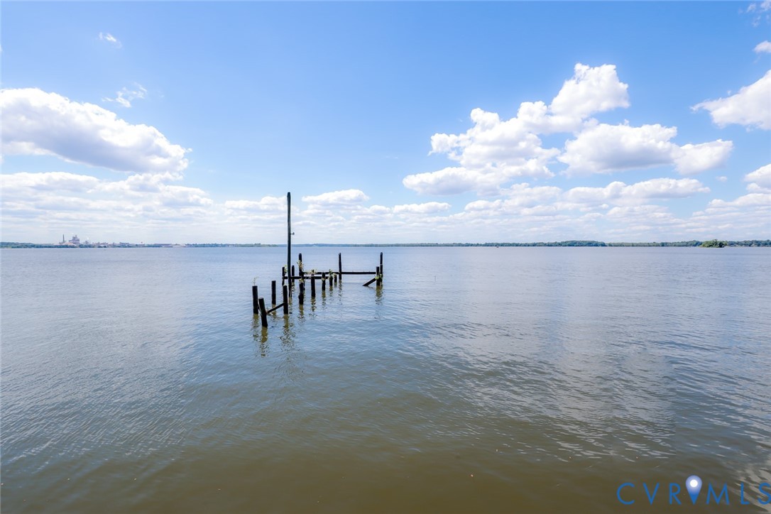 Waterfront parcel featuring an open expanse of water and timber pilings
