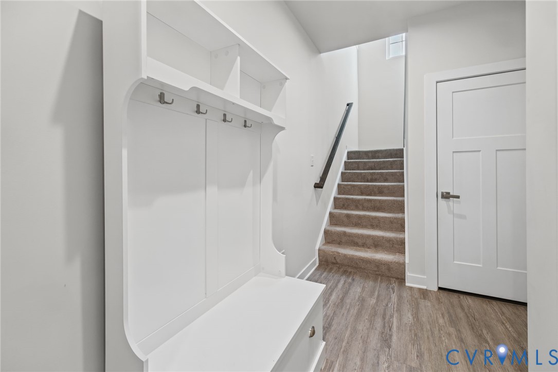 Mudroom complete with dropzone cabinet and coat closet.
