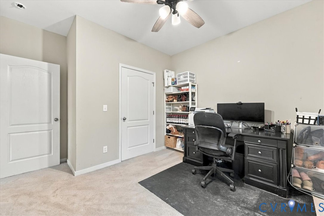 Open-concept kitchen featuring an island with stone-finish countertop, white cabinetry, stainless steel appliances, wood-finish flooring, and vaulted ceilings