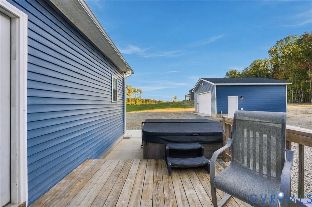 Blue siding exterior featuring a gable roof, covered entryway, and a gravel driveway