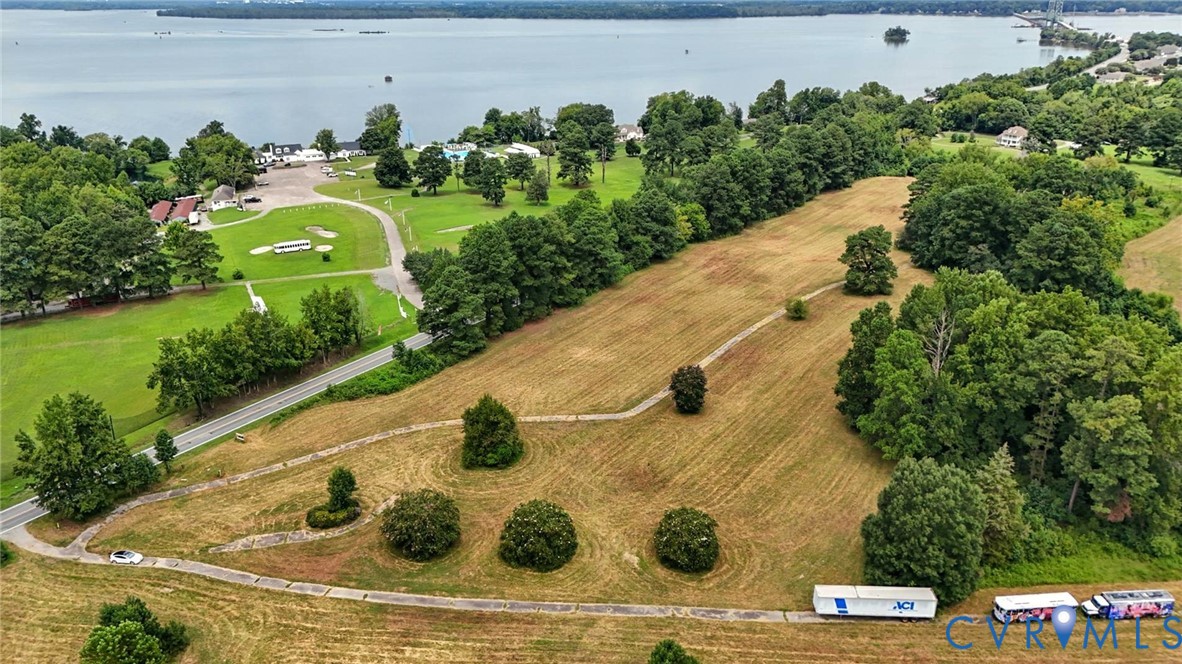 Expansive parcel of land featuring mature trees, rolling topography, and paved pathways Expansive parcel of land featuring mature trees, rolling topography, and paved pathways