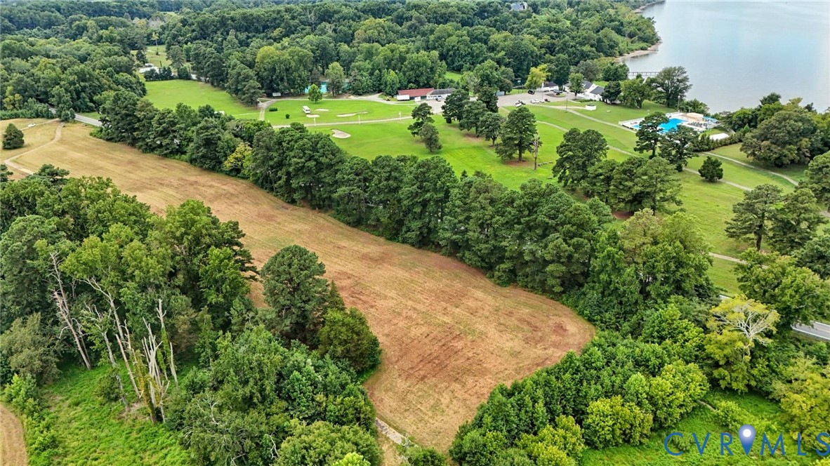 Expansive parcel featuring mature tree lines, open meadow, and established landscaping