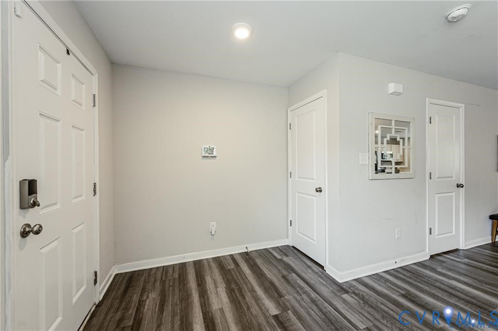 Entry area featuring wood-finish flooring, two-panel interior doors, and a recessed ceiling light