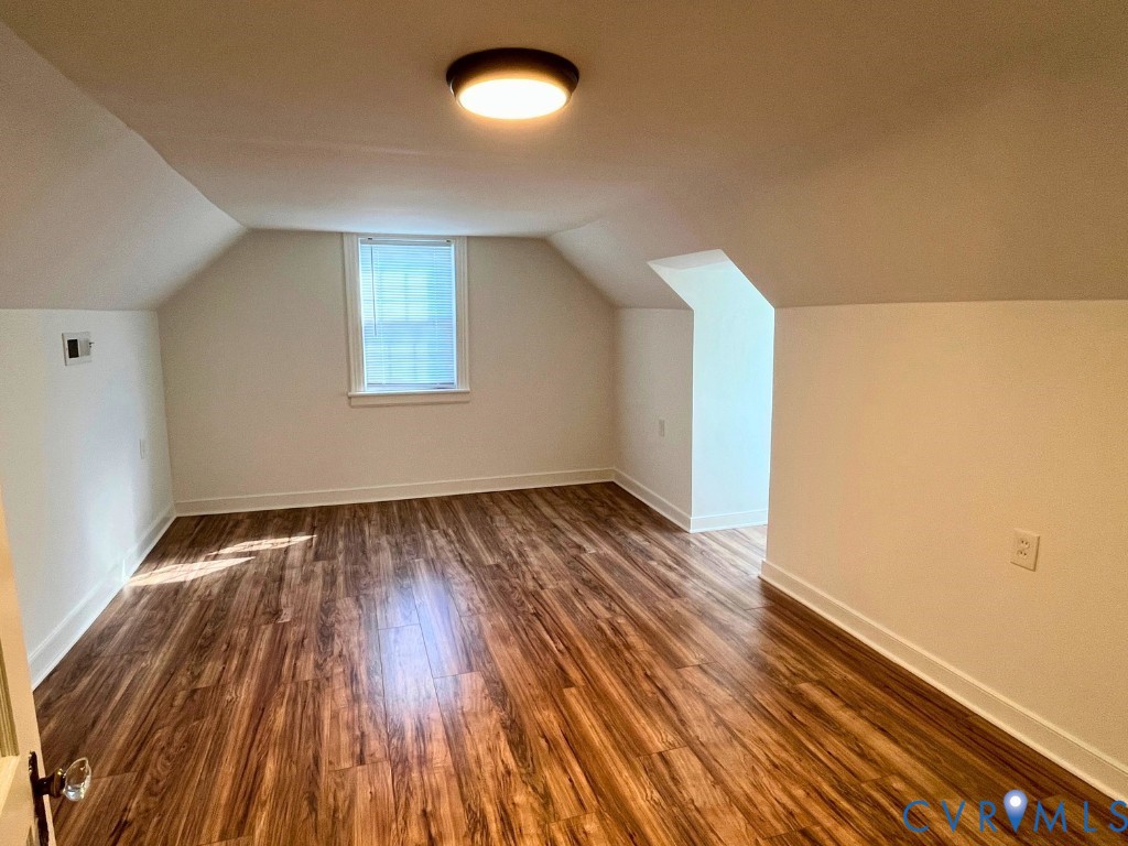 LVP flooring vaulted ceilings, and flush-mount lighting
