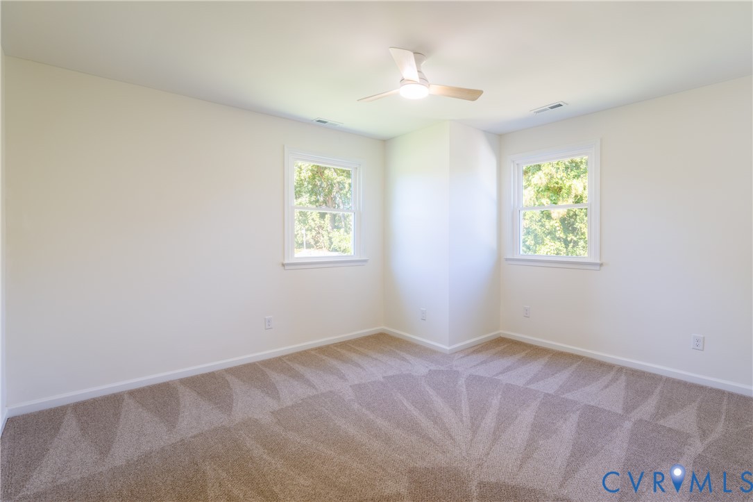 Upstairs bedroom with ceiling fan