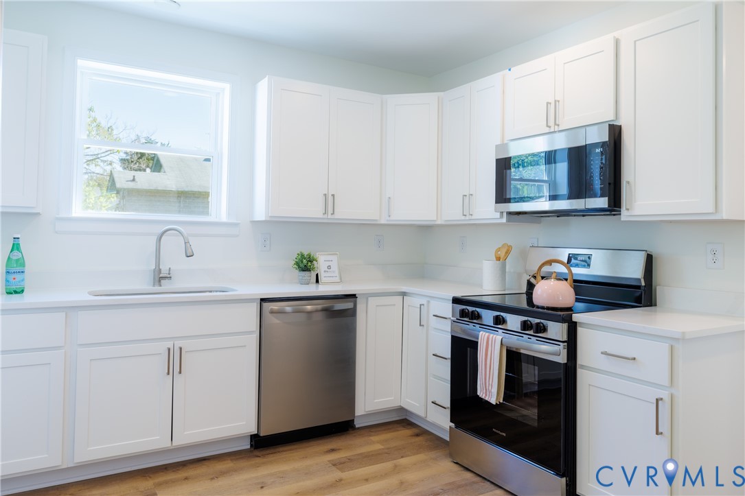 Kitchen with stainless appliances and stone countertops