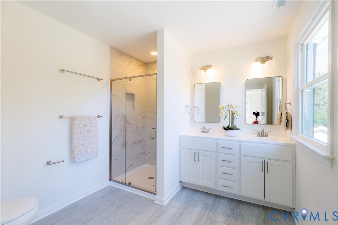 Primary bath with tiled walk in shower