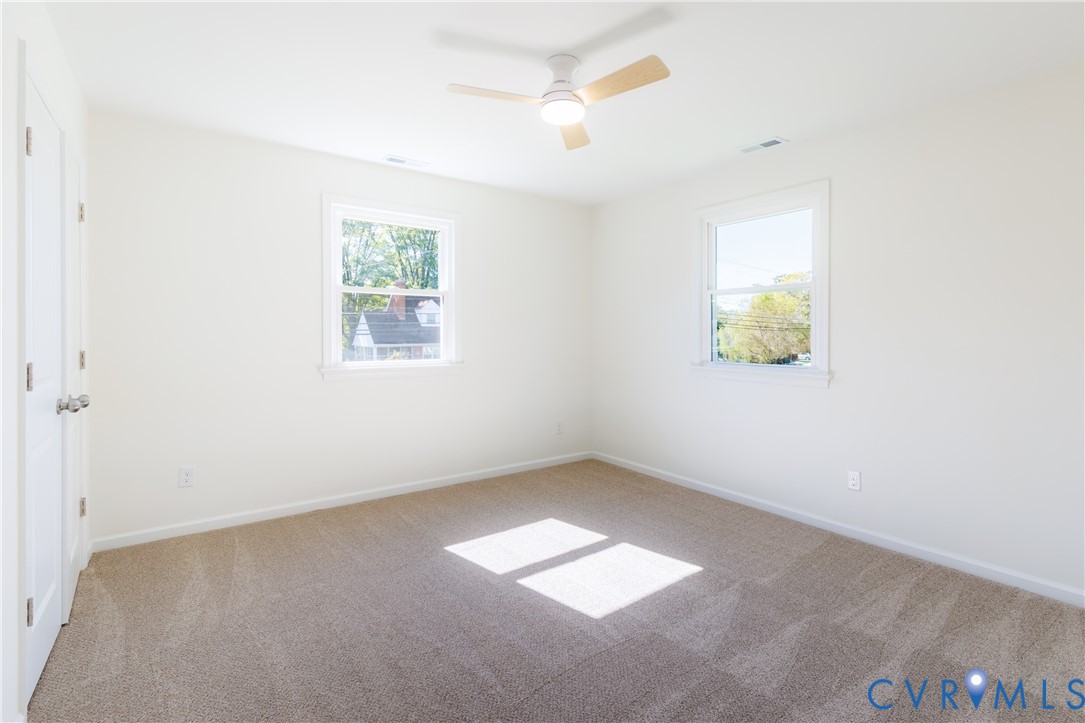 Upstairs bedroom with ceiling fan