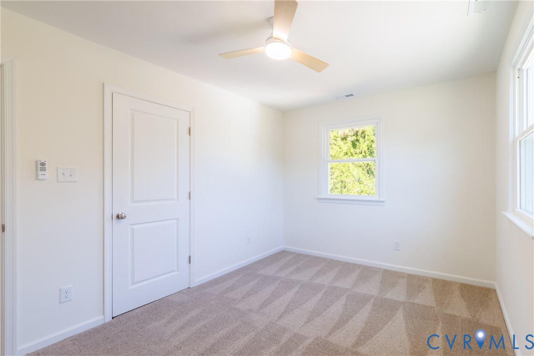 Upstairs bedroom with ceiling fan
