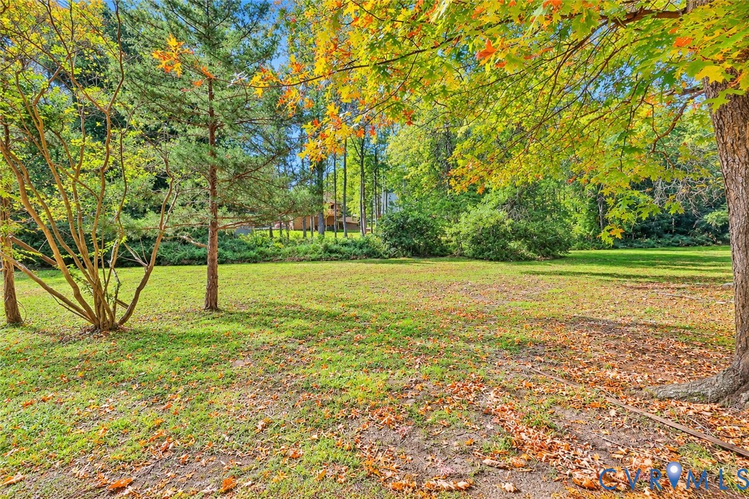 Expansive grounds featuring mature trees and established perimeter landscaping