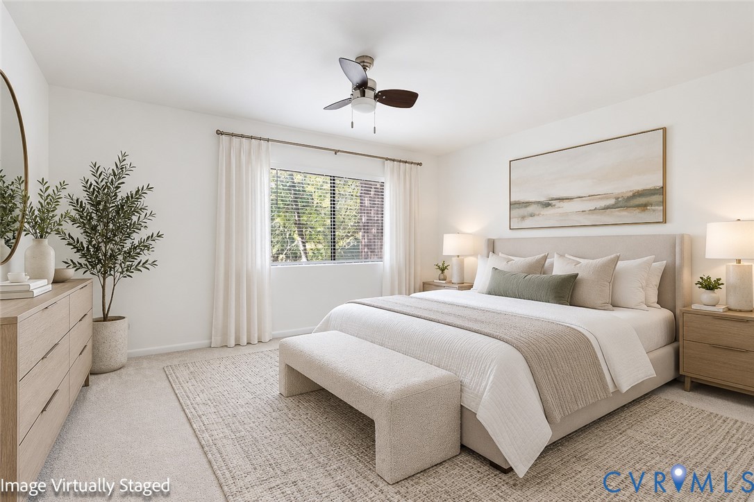 Neutral-toned wall-to-wall carpeting, ceiling fan with integrated lighting, and window featuring horizontal blinds