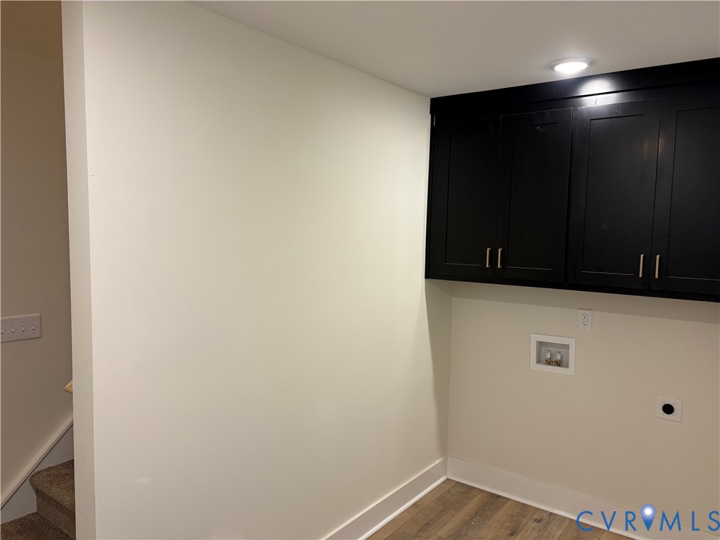 Black built-in upper cabinetry, wood-finish flooring, and recessed ceiling lighting Black built-in upper cabinetry, wood-finish flooring, and recessed ceiling lighting