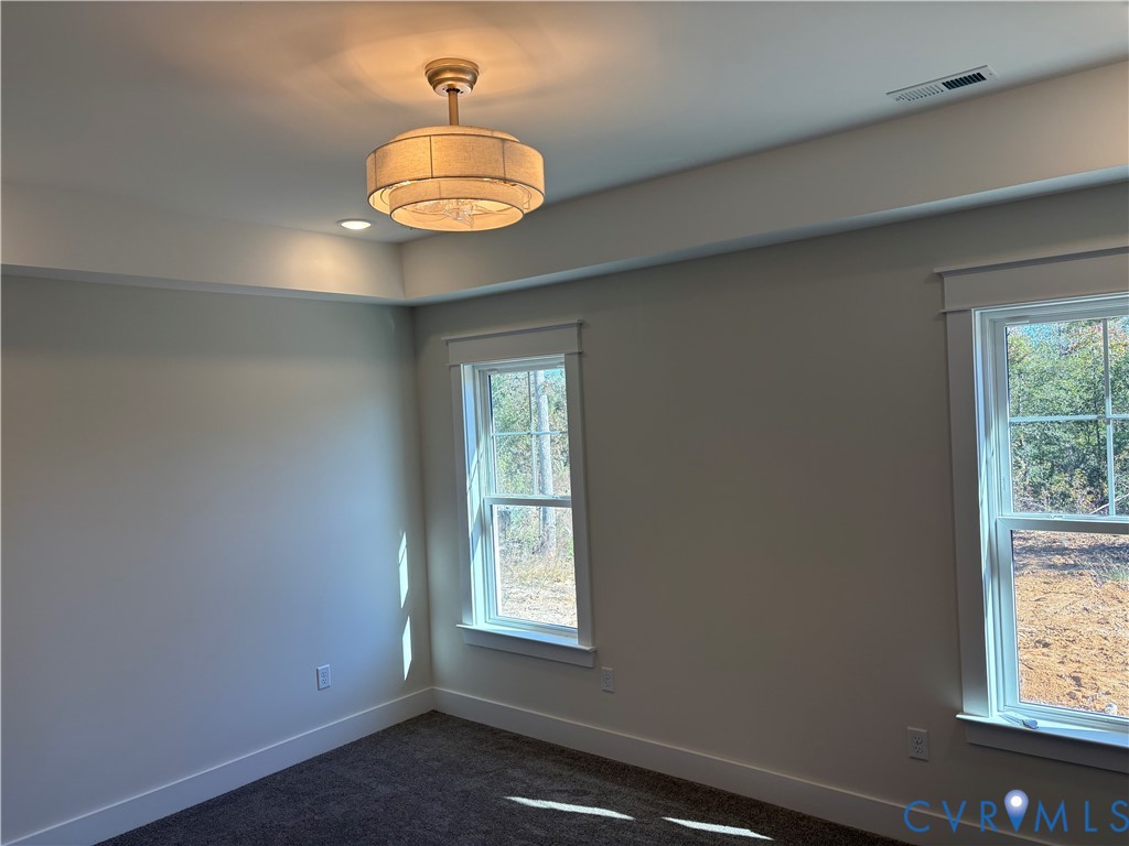 Tray ceiling with recessed lighting, drum-style chandelier, and dual windows with wide-profile casing Tray ceiling with recessed lighting, drum-style chandelier, and dual windows with wide-profile casing