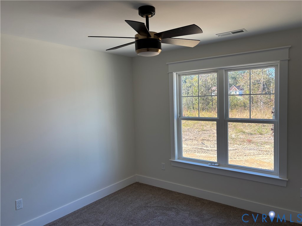 Multi-pane window with detailed trim, neutral wall coloring, and a modern six-blade ceiling fan