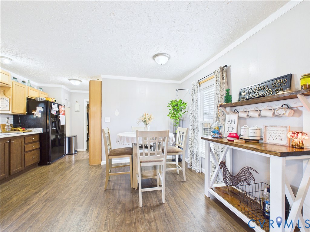 Kitchen featuring light wood-tone cabinetry, wood-finish flooring, and recessed ceiling lighting
