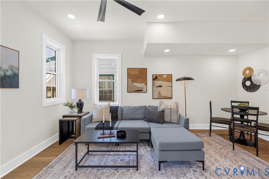 Neutral wall palette, recessed lighting, multi-blade ceiling fan, and wood-finish flooring Neutral wall palette, recessed lighting, multi-blade ceiling fan, and wood-finish flooring