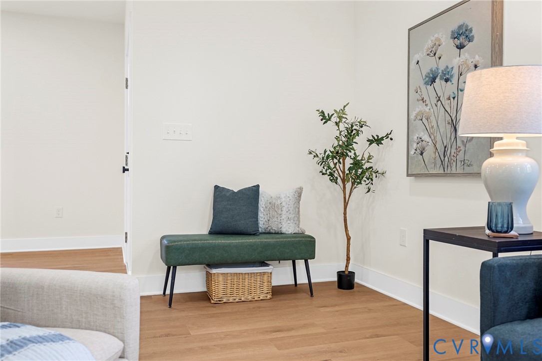 Neutral interior space featuring wood-finish flooring and solid-color wall finishes