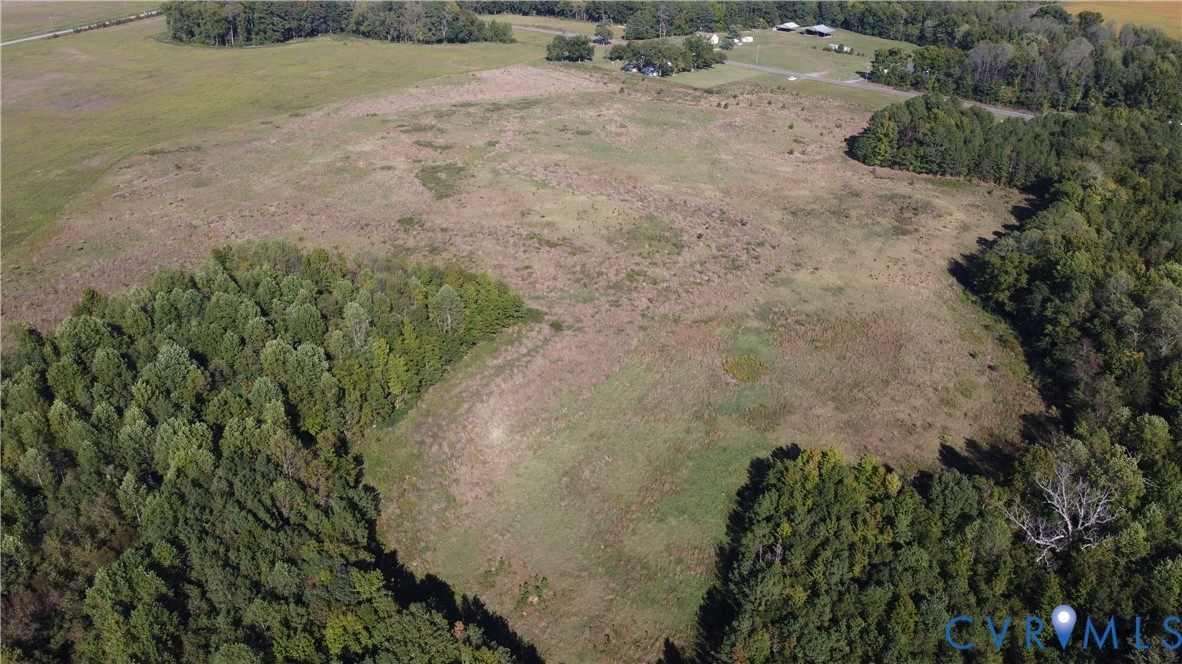 Expansive open acreage featuring cleared meadow space and borders of mature woodland