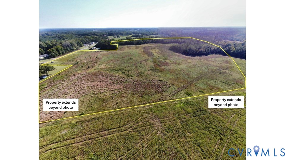 Expansive acreage featuring cleared open terrain, natural meadow grasses, and established perimeter tree lines