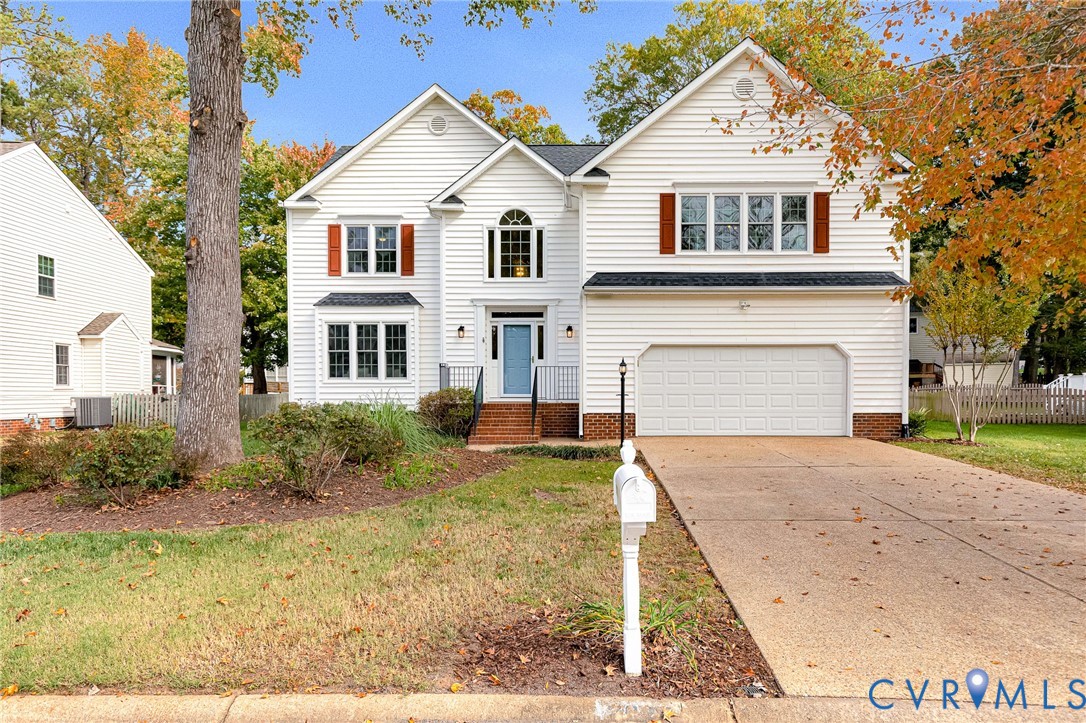 Two-story traditional exterior featuring white horizontal siding, brick foundation detailing, multi-pane windows with decorative shutters, and an attached two-car garage Two-story traditional exterior featuring white horizontal siding, brick foundation detailing, multi-pane windows with decorative shutters, and an attached two-car garage
