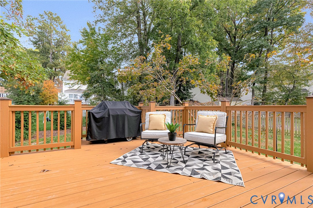 Raised wood-finish deck with vertical baluster railings and natural wood-finish posts