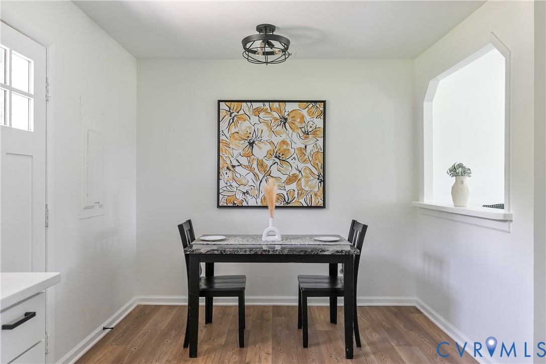Wood-finish flooring, industrial-style cage lighting, and a recessed wall niche